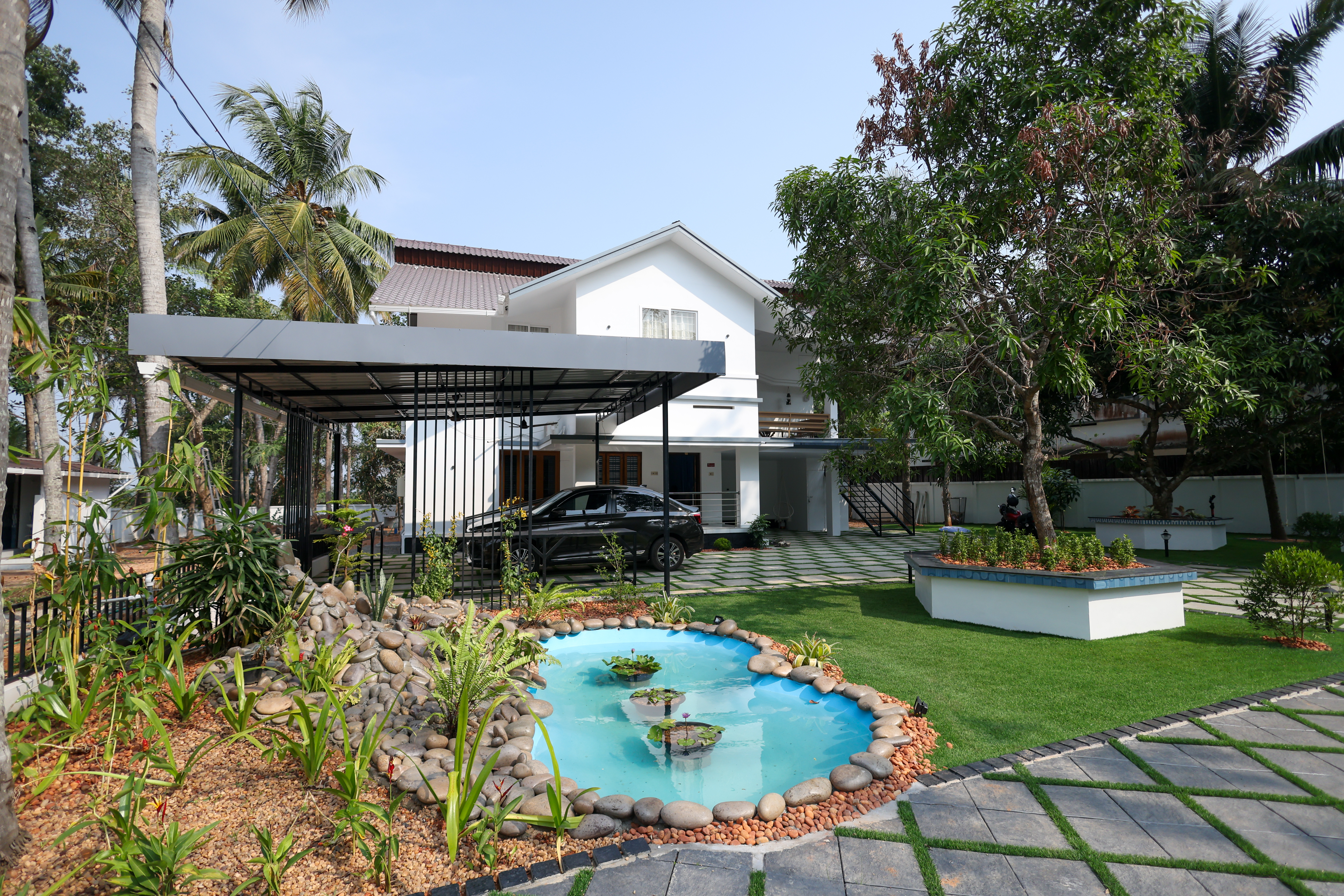 Bright Nest Munroe relaxing outdoor spaces and pool area surrounded by lush greenery